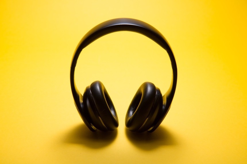 A black headphones on a yeallow background